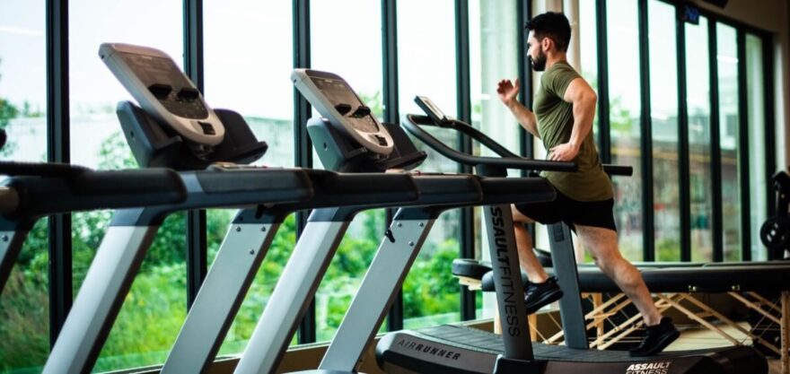 a man running on a curved treadmill in an empty gym